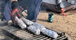 burritos, wrapped in foil and cooking on the campfire grate, make easy breakfasts for camping