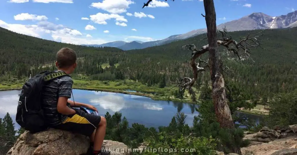 kids taking in the view of a mountain lake