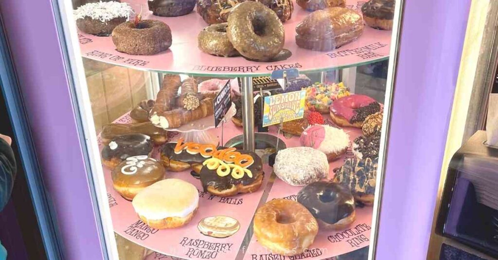 a display of donuts at VooDoo donuts where some of the best sweets in Denver are served