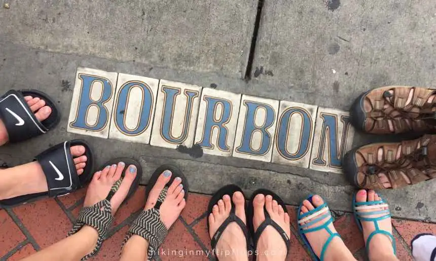 tiles on the sidewalk that spell out Bourbon on Bourbon St in New Orleans