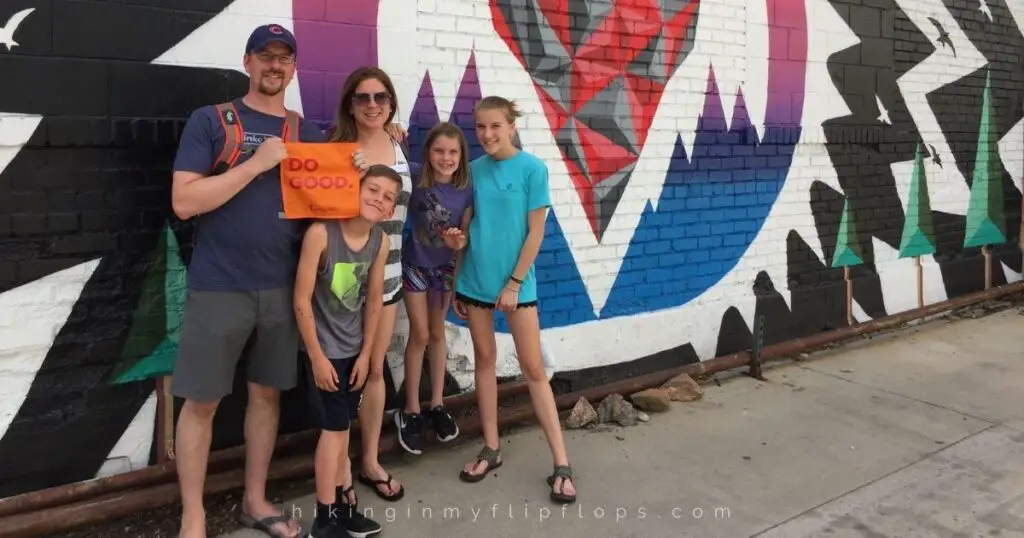a family standing in front of a street mural in Denver Colorado