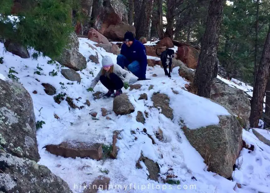 sliding down Mallory Cave trail in the snow in Boulder