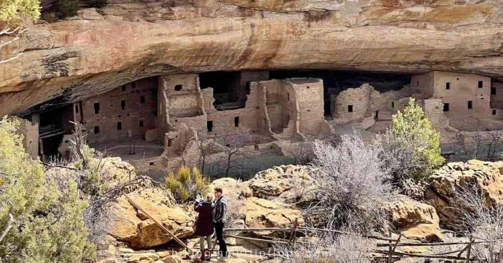 a couple standing in front of one of the cliff dwellings at Mesa Verde NP in Colorado