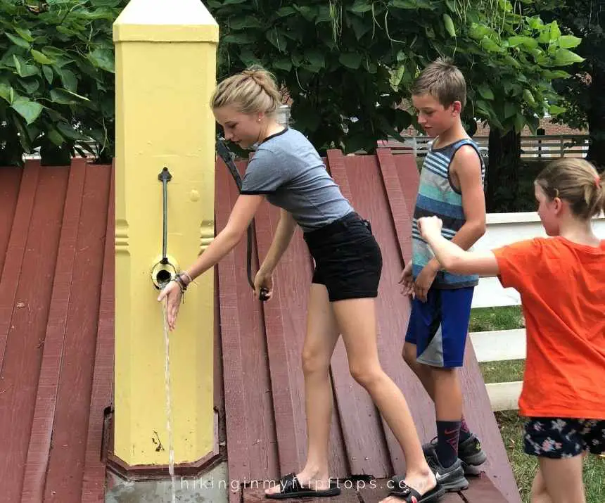 kids using the working water pump at Old Salem in winston-salem NC