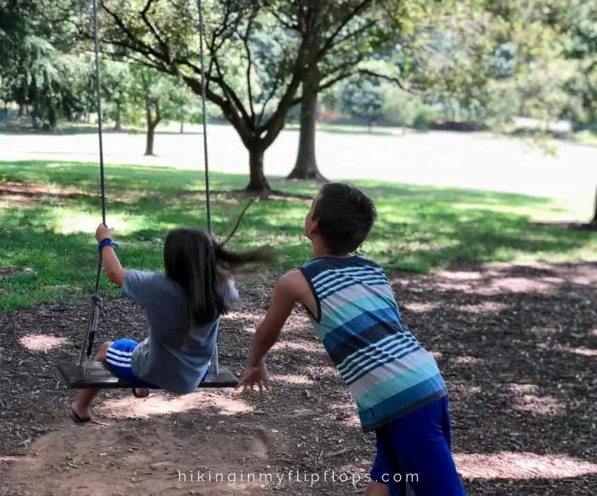 kids playing on swings on wake forest university campus