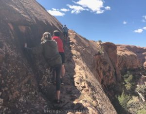 a narrow ledge on the trail to MiddleEarth waterfall in Moab UT