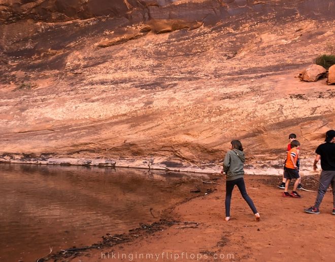 skipping rocks from the pool at the base of MiddleEarth Waterfall in Moab UT
