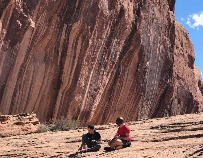 the boys taking a break on the hike to MiddlEearth waterfall in Moab UT