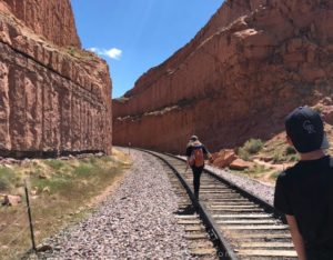 crossing train tracks on the corona arch trail in Moab UT