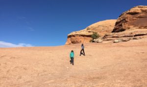 kids walking on the slickrock trail in moab ut