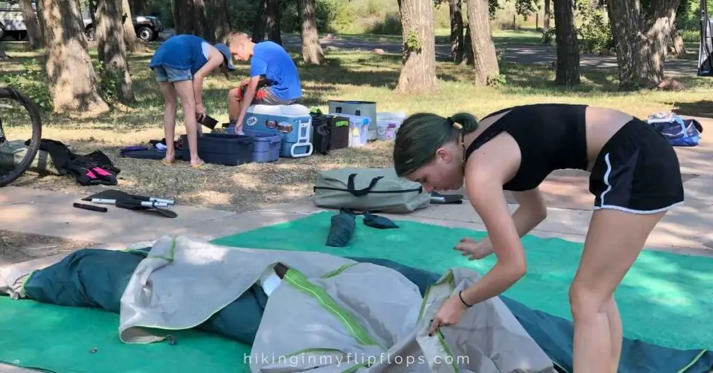 kids helping with set up at a campsite