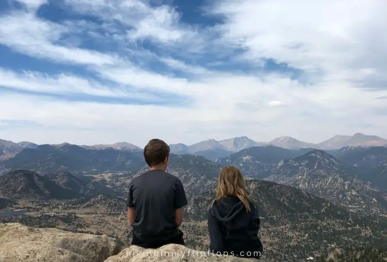 kids sitting on the summit of Kruger Rock Trail, taking in the view of the rocky mountains