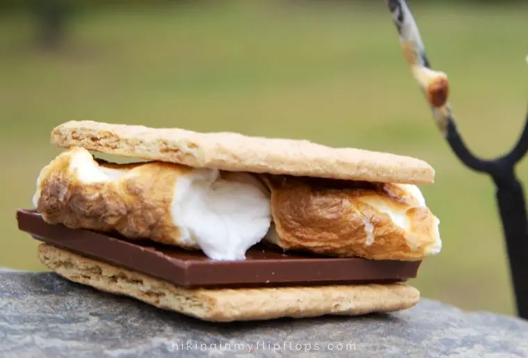a s'more - making this campfire dessert of one of the most popular camping activities at night