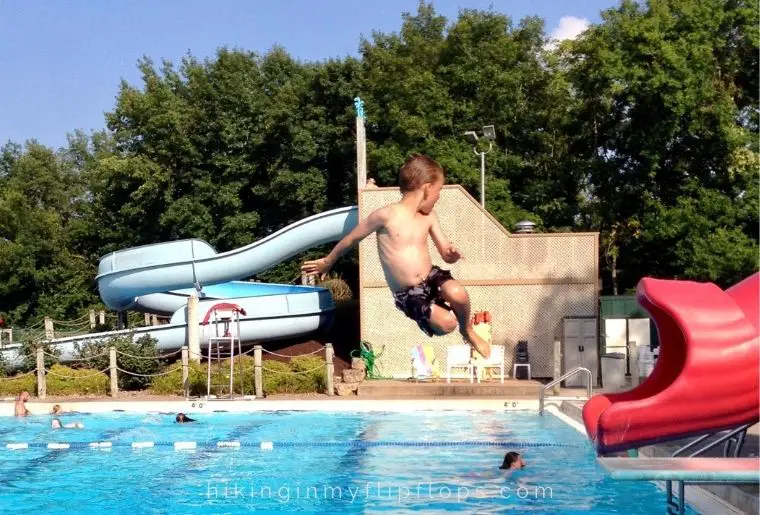 playing on the slide at the community pool for outdoor activities for families