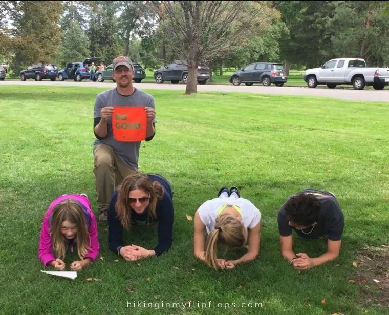 a family doing planks in a Denver park for one of the Questival challenges