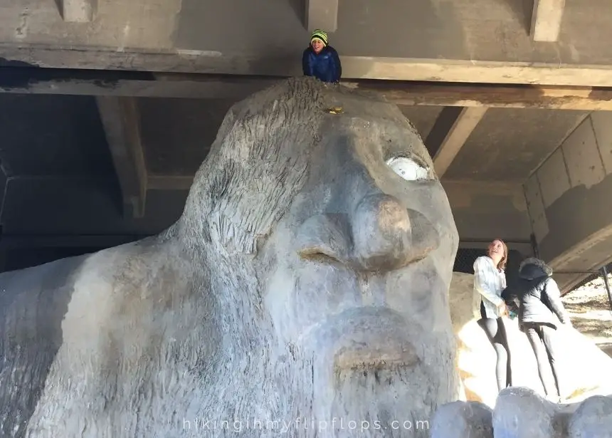 kids climbing on the Fremont Troll, one of the fun sights to see in Seattle, WA