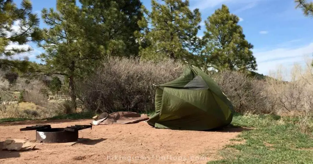 a tent blew over by wind depicts a need to improvise to avoid one of the common camping mistakes