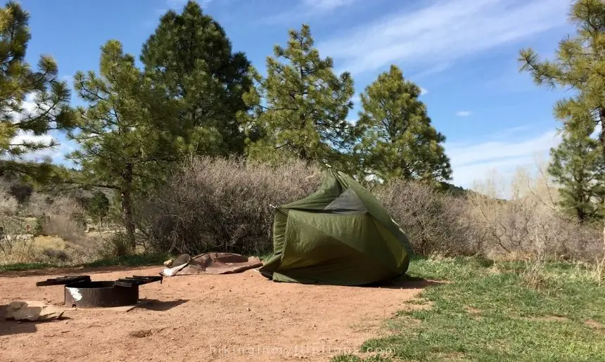a camping tent that blew over from the wind depicting the common camping mistakes