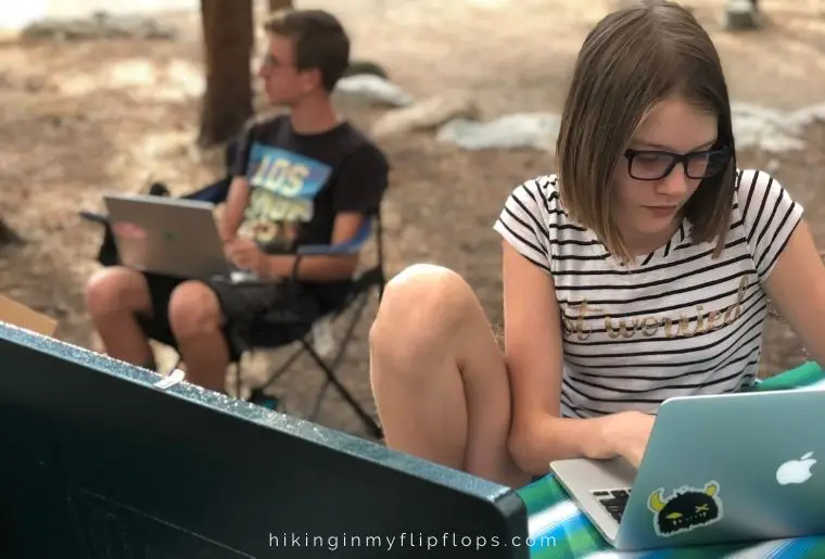 kids doing school work at a campground, one of many things to do when camping