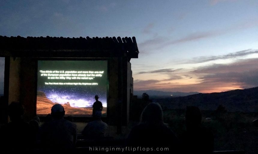 a silhouette of a park ranger in front of an outdoor video, showing things to do at Great Sand Dunes National Park