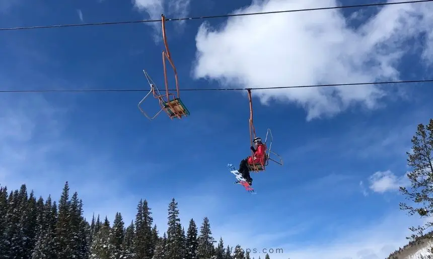 a girl on a chair lift at a ski resort