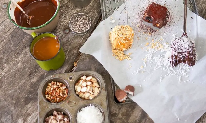 a board of roasted marshmallows dipped in chocolate then in various toppings for a s'mores alternative 