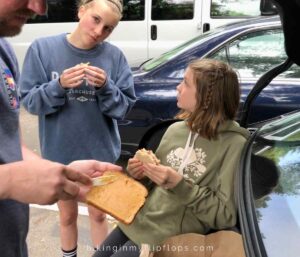 a family making peanut butter sandwiches on a road trip