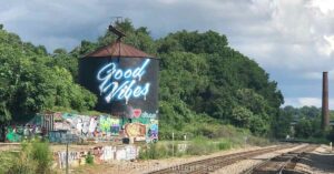 asheville's water tower mural in the river arts district with a "good vibes" message