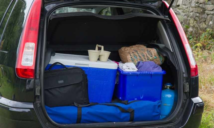 the back of an SUV that depicts how to pack a car for camping