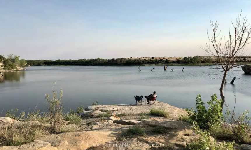 a man sitting by a lake in New Mexico appears inspired by one of many great outdoors quotes