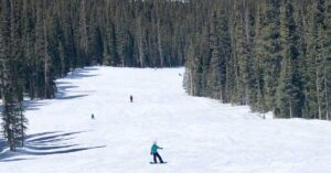 snowboarding on a run at Copper Mountain, one of the best family ski resorts in Colorado
