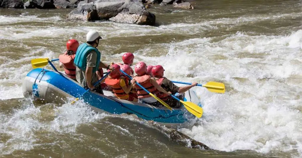 people in a boat white water rafting in the Colorado River