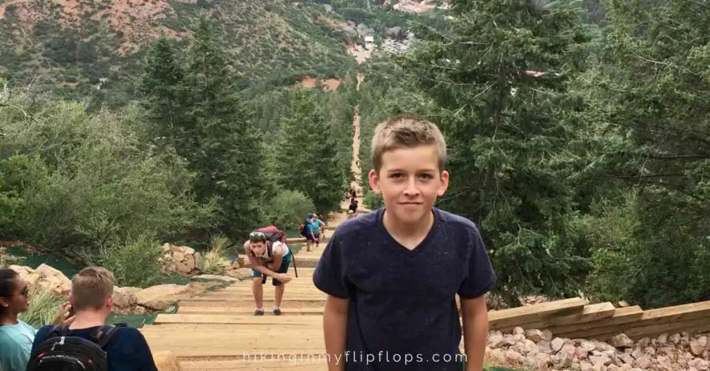 a boy standing towards the top of the Manitou Incline in Colorado