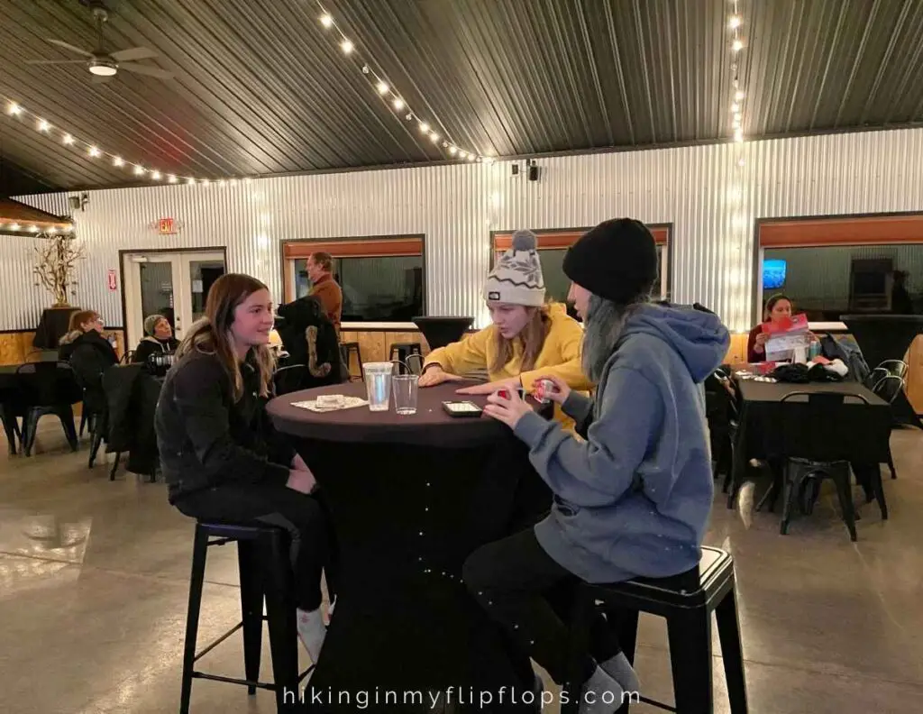 kids at a high top table playing games while waiting for the northern lights to come out