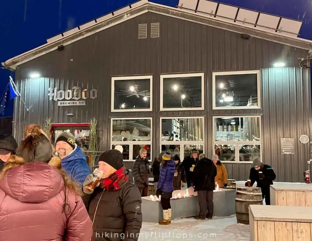 people standing around firepits outside of HooDoo Brewing in Fairbanks AK