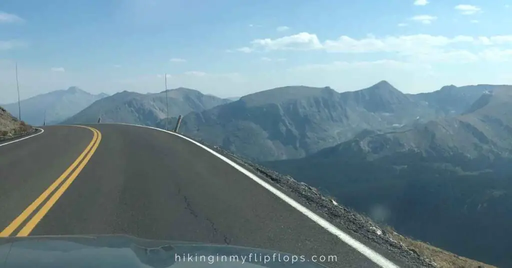 a road in the colorado mountains depicting a colorado road trip itinerary