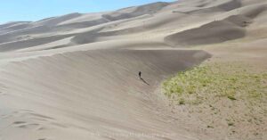 a kid running through the massive dunefield at Great Sand Dunes National Park & Preserve