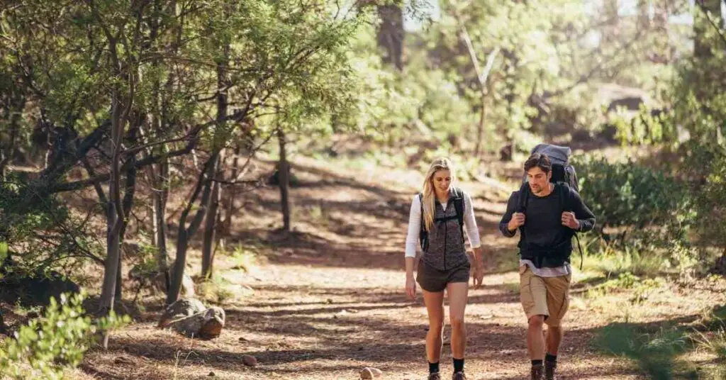 a couple walking along a hiking trail