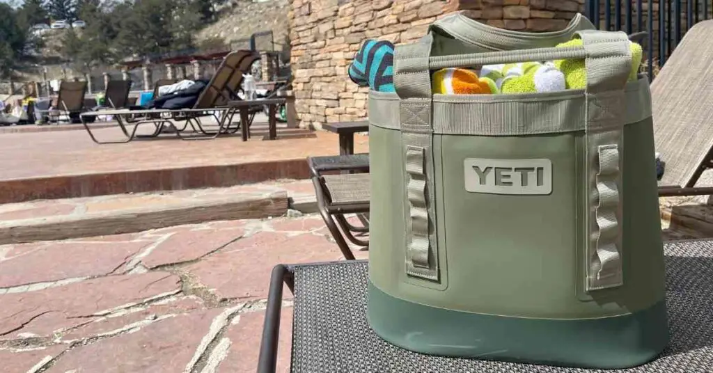 the Yeti 35 Carryall tote on a pool lounge filled with beach towels shows best beach totes for moms