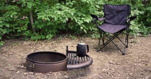 a camping chair by a campfire depicting the best heavy-duty camping chair
