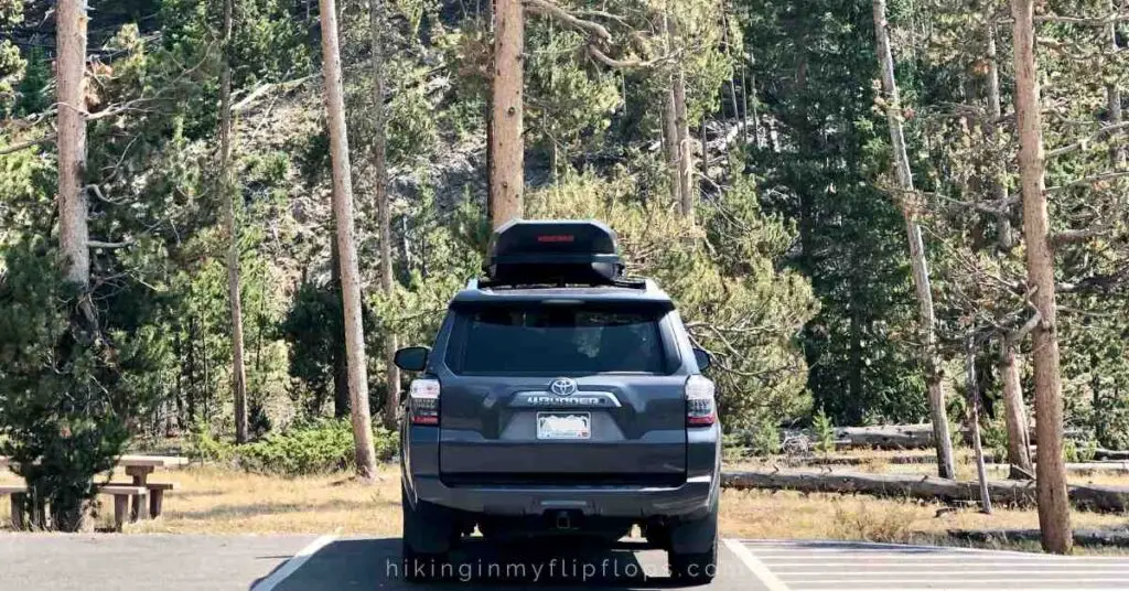 the back of an SUV shown to illustrate family road trip essentials and packing list