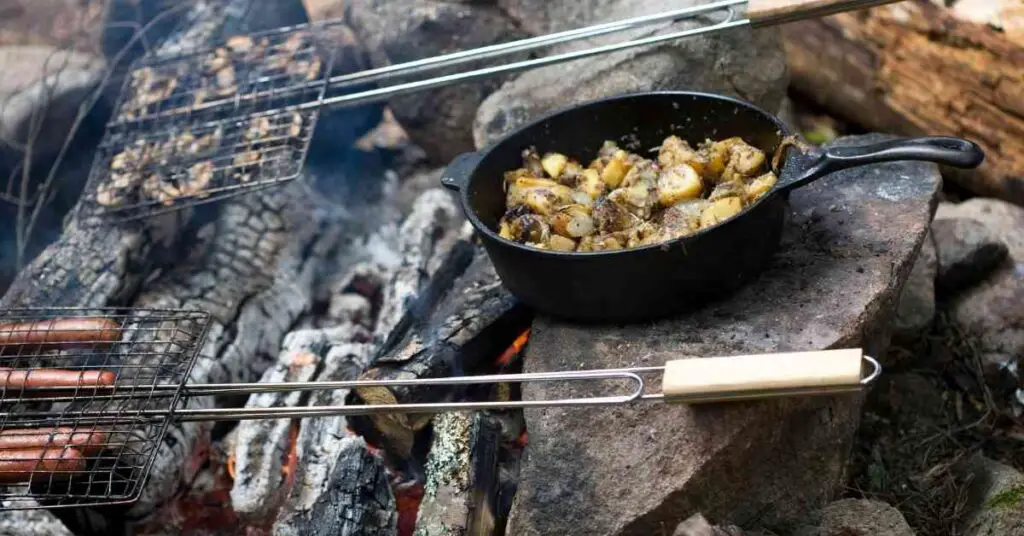 a cast-iron skillet and cooking baskets for cooking an outdoor meal 