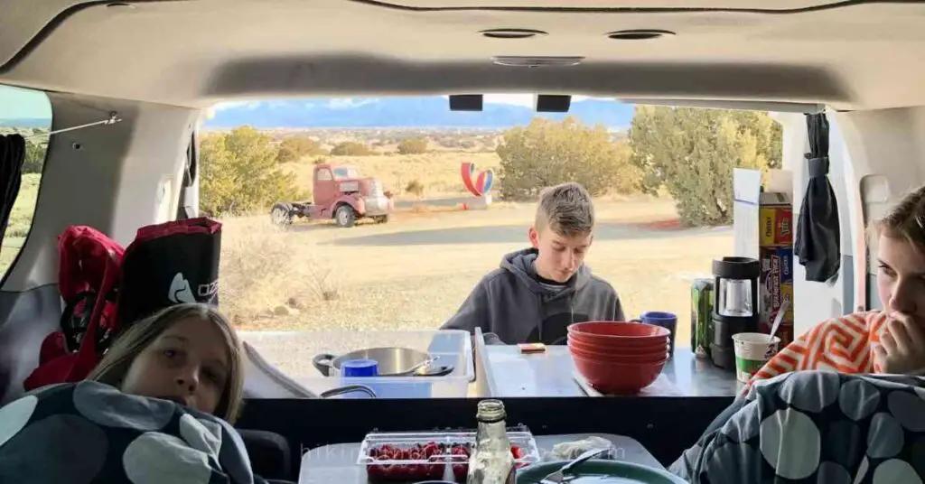 a boy using the camp kitchen to make easy campervan meals