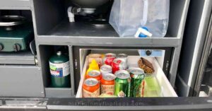 a fridge drawer stores perishable foods for cooking in a campervan