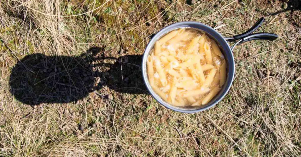 a pot with pasta cooking illustrates how to boil water camping
