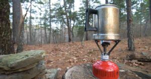 a backpacking stove, shown with a kettle, is a good way to boil water while camping